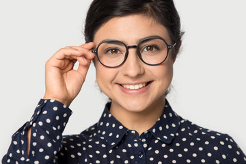 Portrait of indian girl in glasses posing on grey background