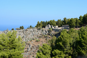 Fototapeta na wymiar The slope of La Rocca mountain near the Cefalu city on a sunny summer's day. Sicily, Italy