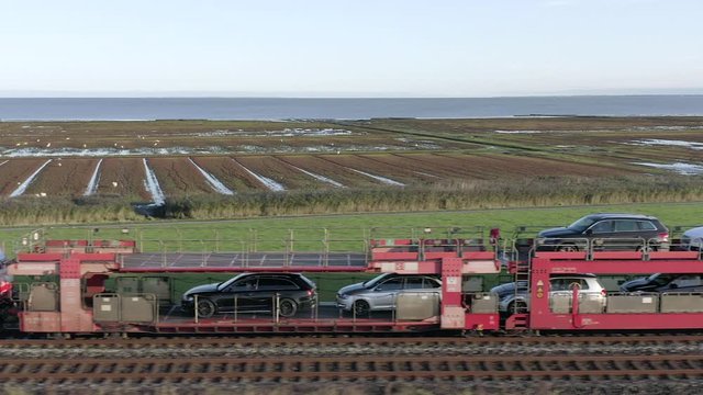 Moto Rail Train Carrying Vehicles and Passengers on a Journey