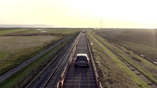 Moto Rail Train Carrying Vehicles and Passengers on a Journey