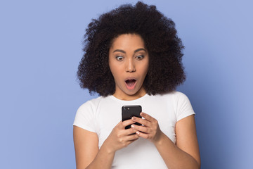 Surprised biracial young woman feel stunned by cellphone message