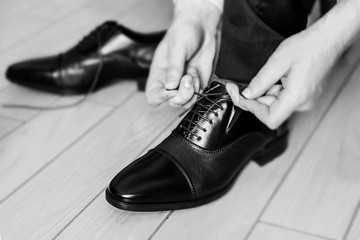 Businessman wearing his leather shoes