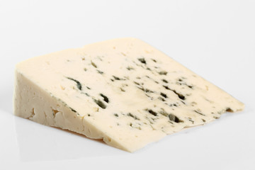 Blue cheese. Isolated on gray background.