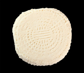Capreggio Goat Cheese. Isolated on black background. Directly Above.
