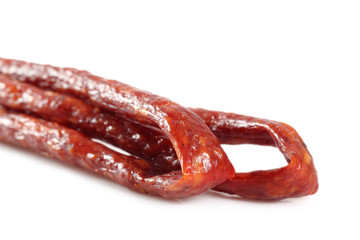 Kabanos. Polish long thin dry sausage made of pork. Isolated on white background.
