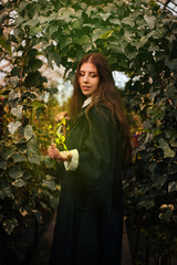 A girl from the school of young wizards with a magic wand in his hand. Green magic. A sorceress...