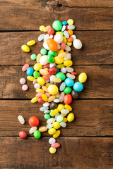 Various kinds of colourful sweets on wooden table. Top view