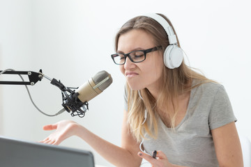 Naklejka premium Music, dj, blogging and broadcasting concept - Female radio host with a funny expression, close-up