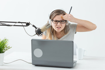 Blogger, streamer and people concept - Funny young woman DJ working on the radio