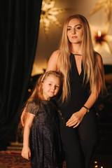 Obraz premium Beautiful blond hair mom with cute daughter in christmas time. Happy family