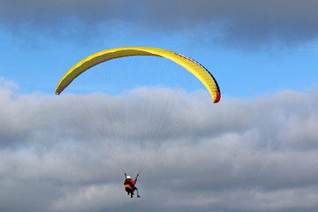 Tandem Paraglider flying wing in a blue sky