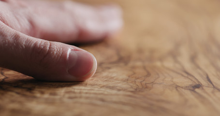 man hand touch oil finished olive wood surface