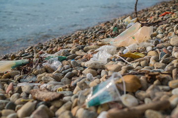 Garbage plastics on the rock beach