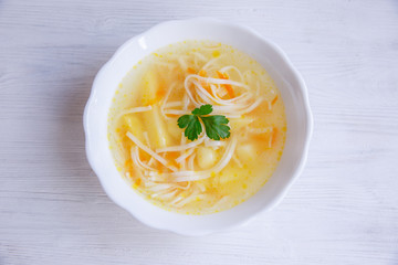 Chicken noodle soup on white background