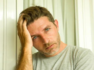 Obraz premium dramatic portrait of sad and depressed 30s or 40s man in pain feeling stressed and broken suffering depression problem and anxiety crisis looking desperate crying lonely