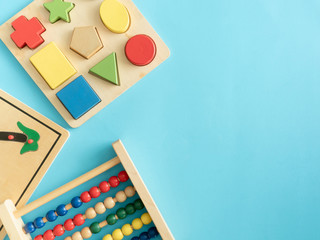 kids learning concept with stacking toys on blue table background.