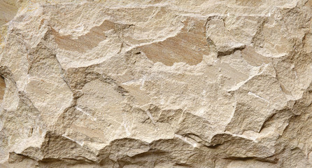 Beige stone grunge background, rock wall with rough texture