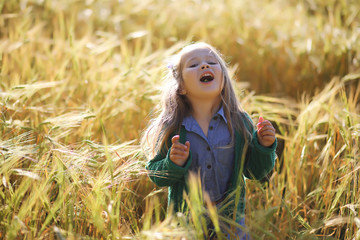 A young mother walk in wheat fields