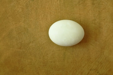 boiled  salty egg on wooden chop block in kitchen