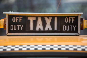 a closeup view of vintage taxi sign at big city