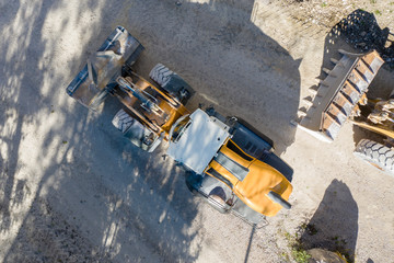 top view of heavy wheel loaded top loader digger on lime stone gravel