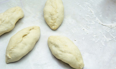 Woman sculpts pies with potatoes. Concept - work in the kitchen