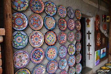 multi-colored decorative plates on the wall of the house