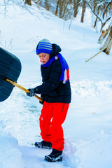 Cleaning snow in winter, the boy shovels snow. 2019