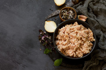 Minced meat and ingredients for cooking minced meat in a bowl on a slate. Free space for your text.