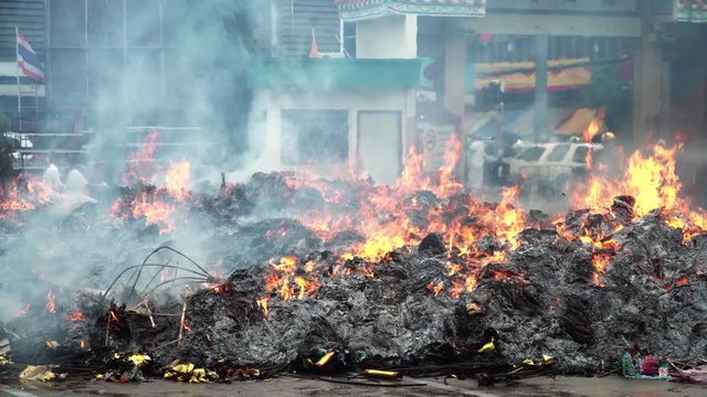 	 Texture of burning joss paper known as ghost money in ceremony faith of Chinese people. Global warming and environmental pollution concept. fire on black background in 4K