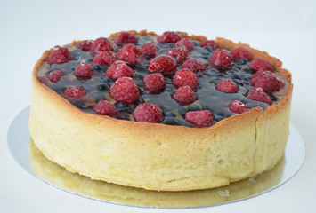 Cheesecake with berries on a white tablecloth