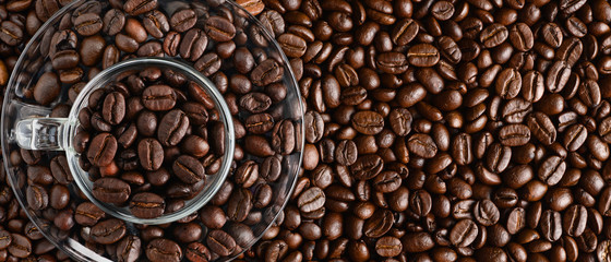 coffee background of coffee beens in red cup on roasted arabica coffee beans background