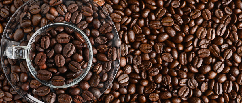 coffee background of coffee beens in red cup on roasted arabica coffee beans background