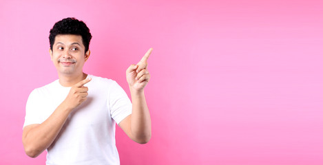 Asia man with a finger On a pink backdrop in studio.