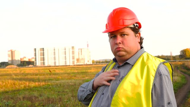 Construction worker showing new building site