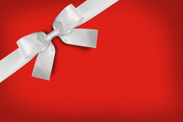 White gift bow on red