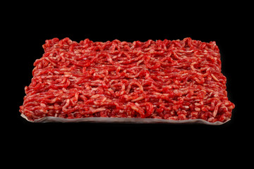 Chopped raw meat  on a black  background.