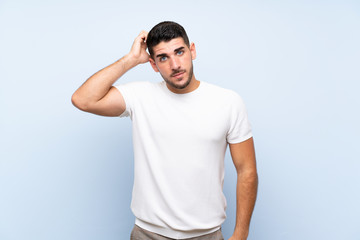 Caucasian handsome man over isolated blue background with an expression of frustration and not understanding