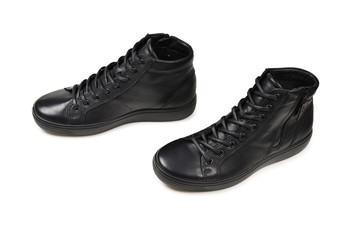 Men's black leather shoes and a black camera on a isolated on white background. Copy space.