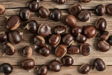 ripe and fresh chestnuts on a wooden table