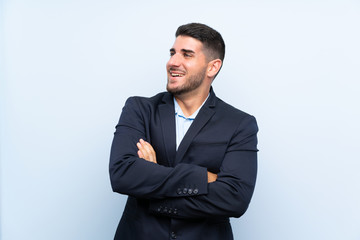 Handsome man over isolated blue background happy and smiling