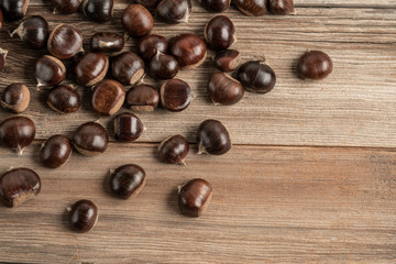 ripe and fresh chestnuts on wooden table with copy space