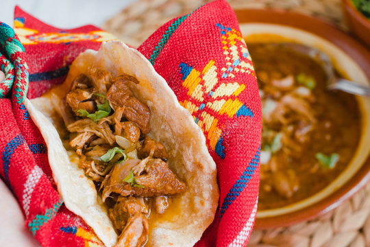 Taco de birria close-up. This taco is typical from Jalisco, Mexico, is spicy and it is usually eaten with mexican style beef stew