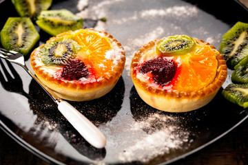Fruit pie placed on a dark modern dish