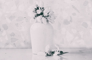 White little flowers on vintage background, textured spring background with snowdrops, high key...