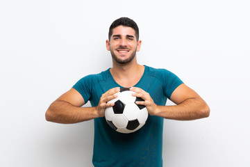 Handsome young football player man over isolated white wall