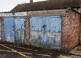 Despite the fact that the garage doors are grungy and have paint peeling off them children are...