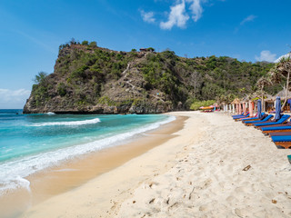 Indonesia, october, 2018: Sea coast view with little houses standing on the beach near by sea. Atuh beach, Nusa Penida island. Popular travel destination on Bali holidays.