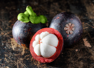 Closeup view of fresh mangosteen on wooden table
