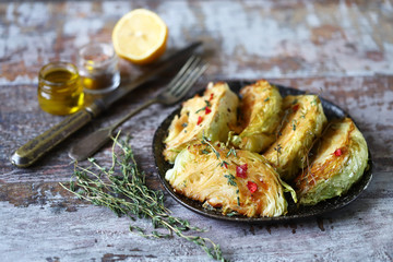Selective focus. Macro. Grilled cabbage slices with aromatic herbs.